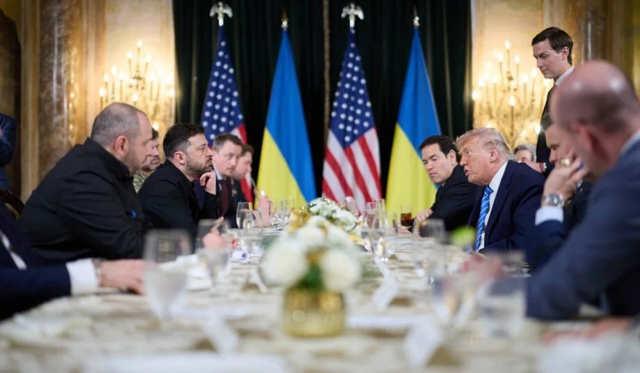 Дональд Трамп і Володимир Зеленський за столом переговорів із прапорами США та України