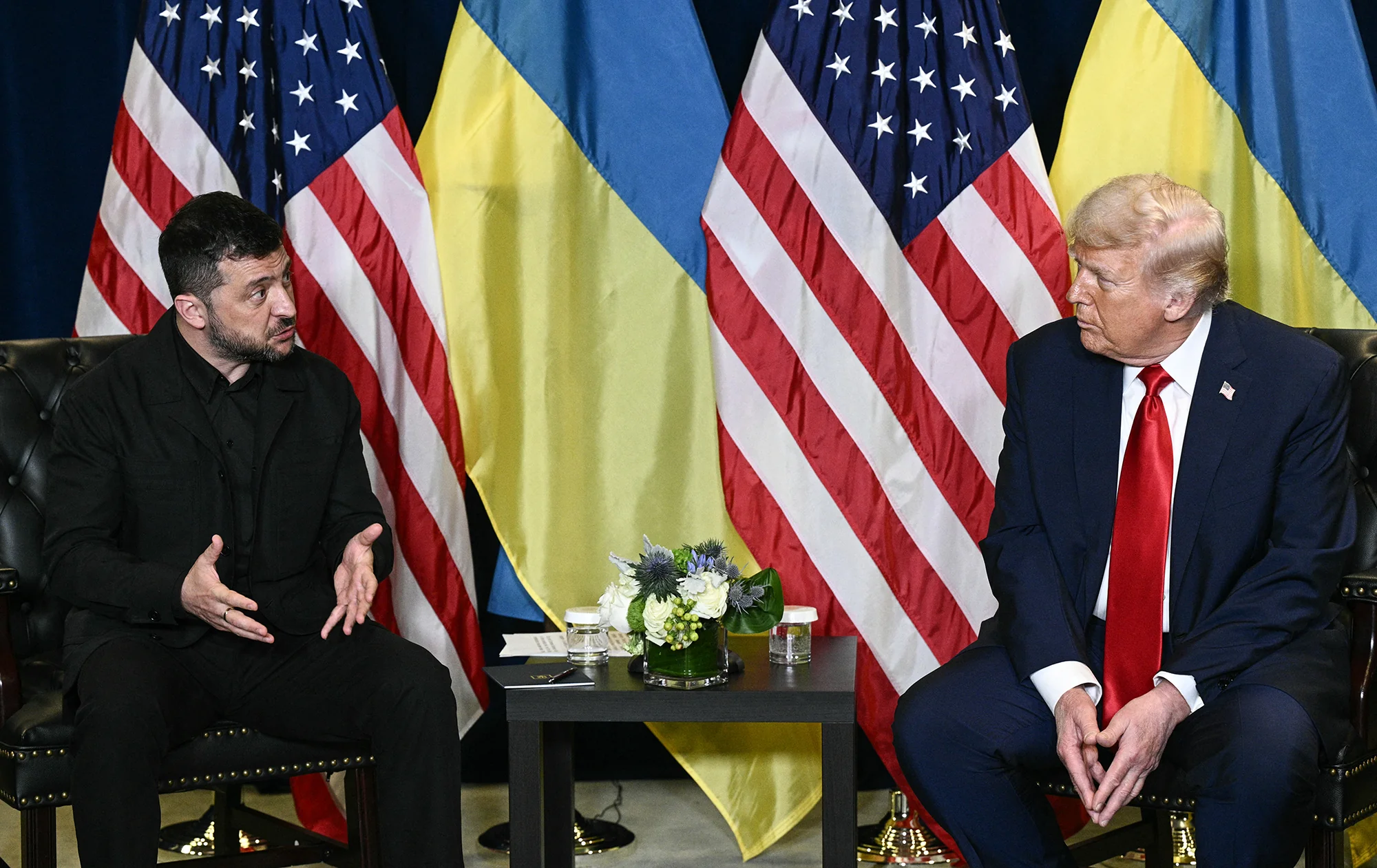 Зеленський і Трамп під час двосторонньої зустрічі з прапорами США та України