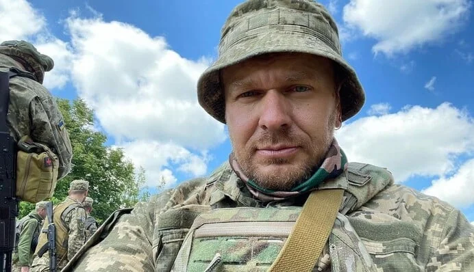 Олександр Положинський у камуфляжі та панамі під час служби в армії